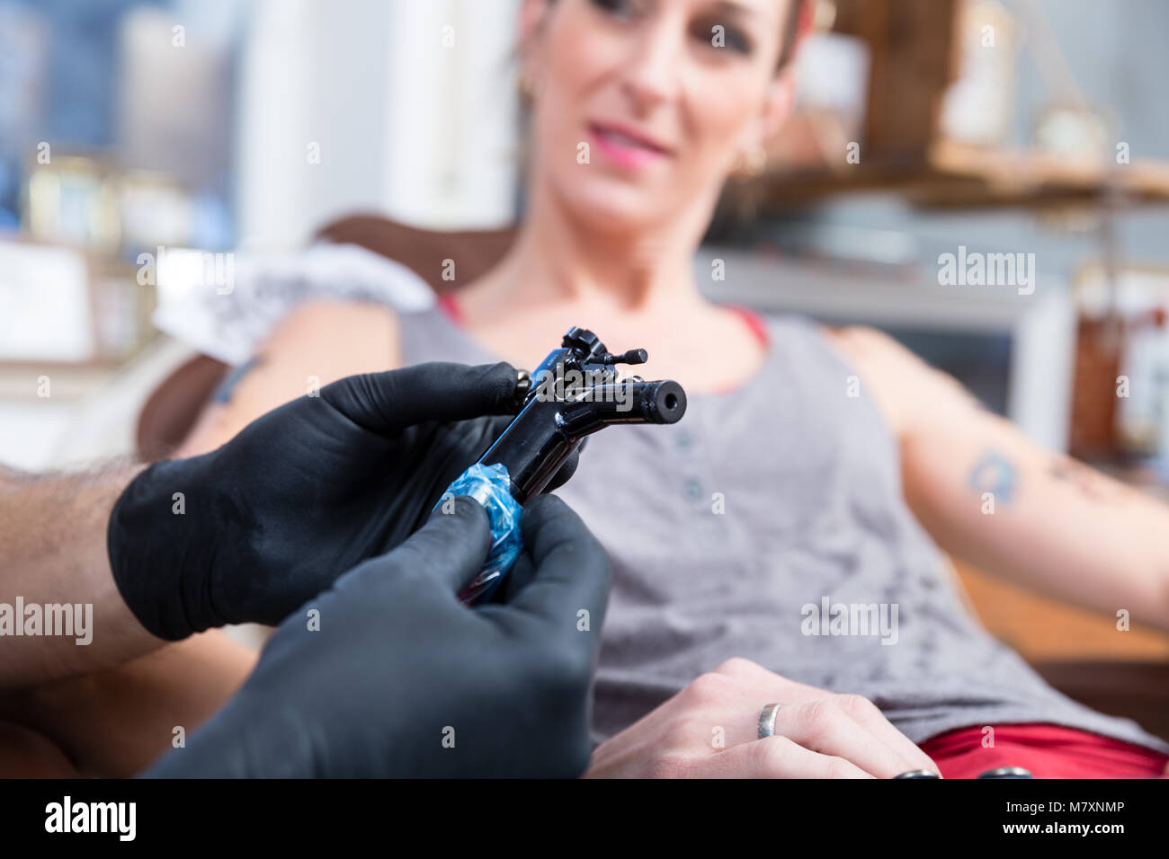 Hands of tattoo artist wearing sterile gloves Stock Photo