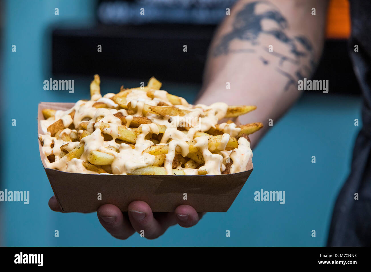 Cheesy fries to takeaway. Stock Photo