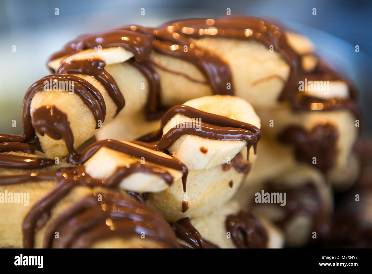Banana and chocolate churros. Stock Photo