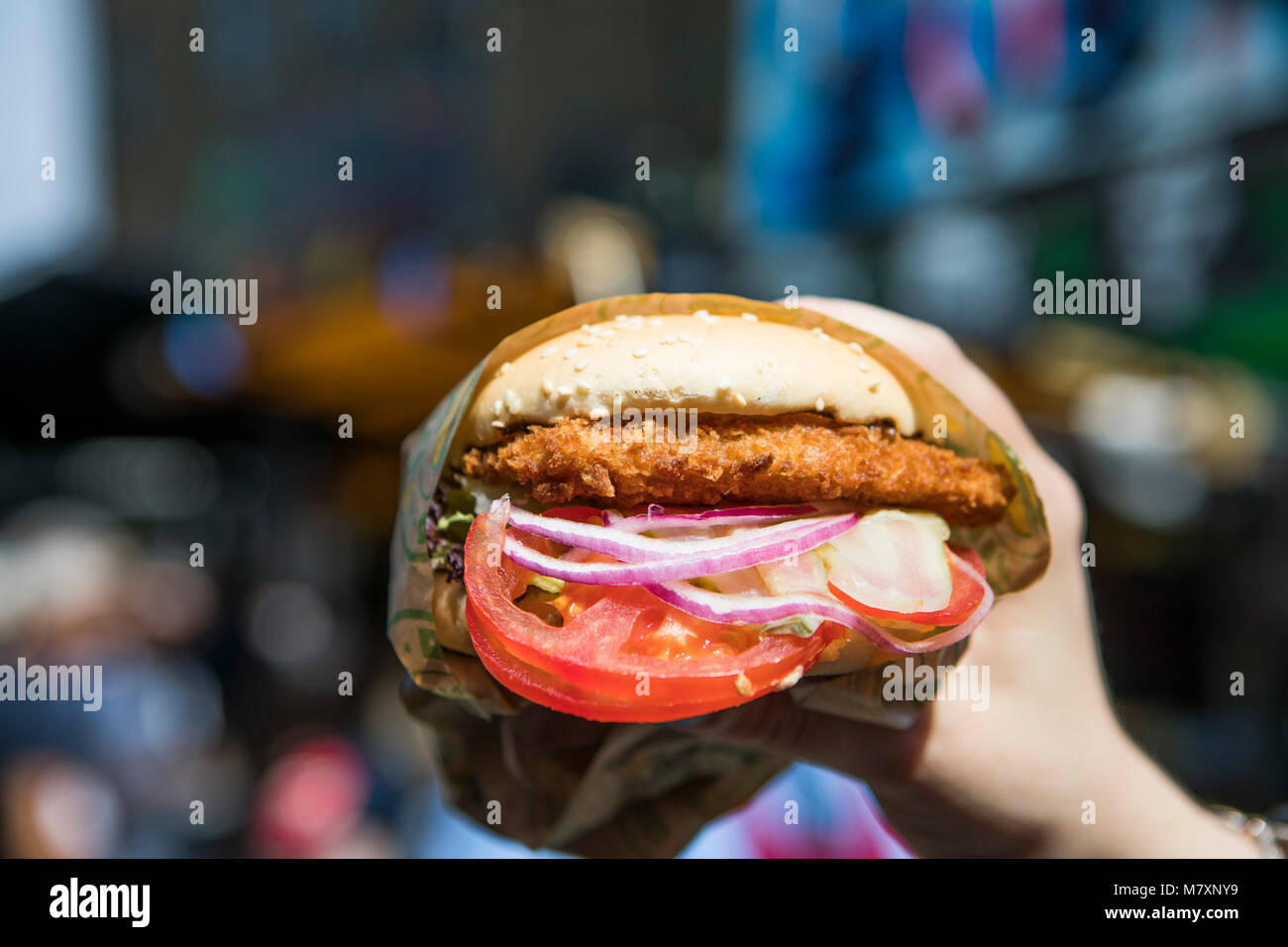 Vegan deep fried Seitan burger with tomatoes and onions Stock Photo