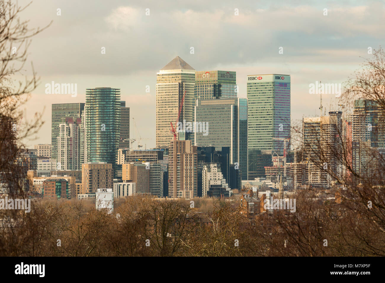 LONDON, UK – JAN 2018:  Modern towers of Canary Wharf seen from Greenwich park during sunset Stock Photo