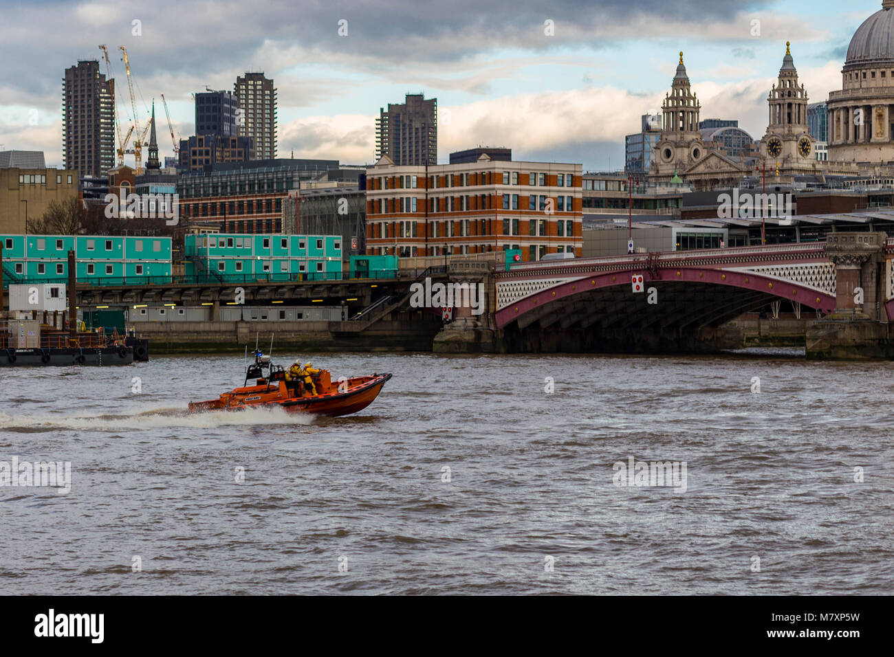 LONDON, UK – JAN 2018: Orange speedboat on River Thames on winter day Stock Photo