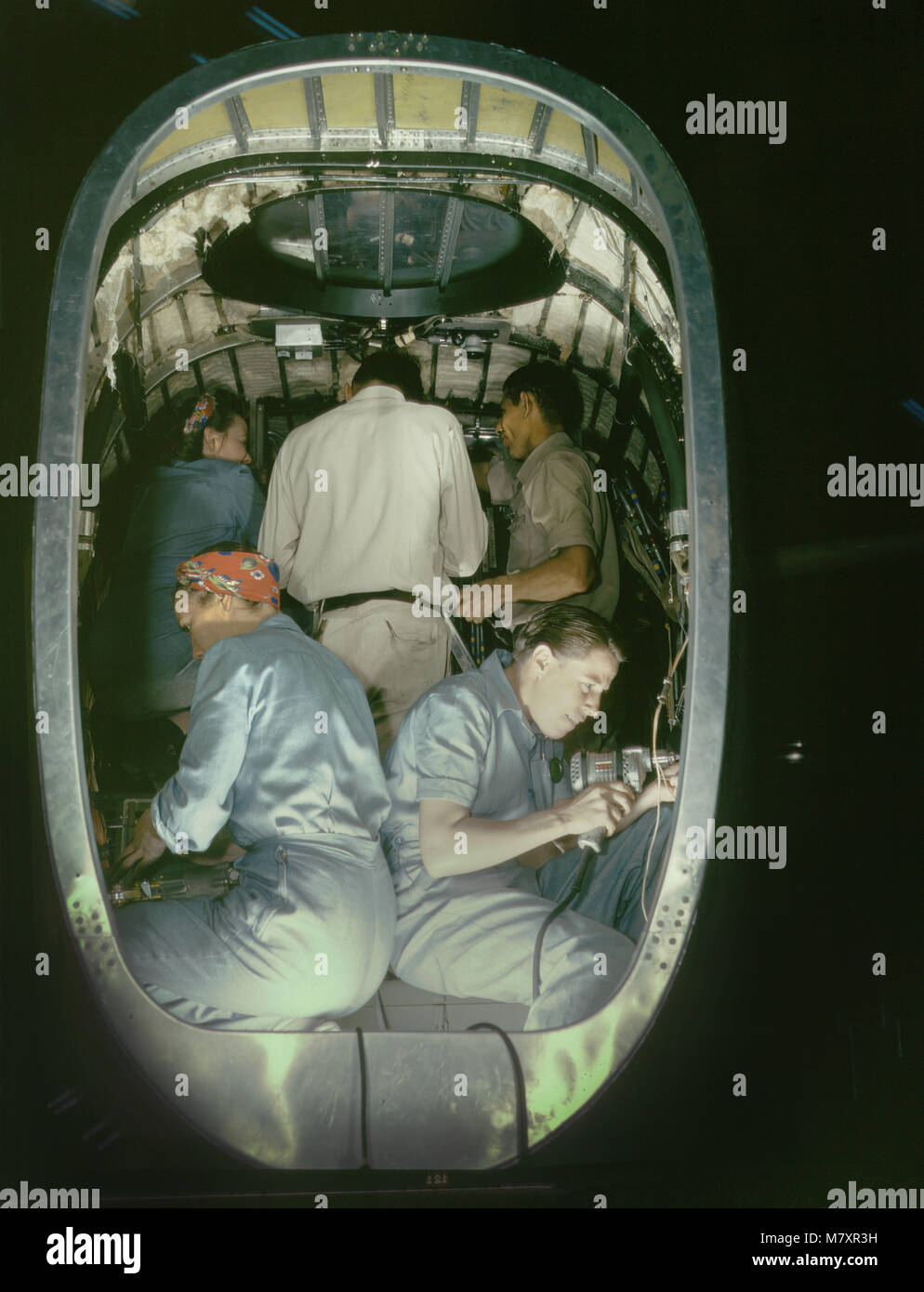Group of Men and Women Working inside Fuselage of Liberator Bomber, Consolidated Aircraft Corp., Fort Worth, Texas, USA, Howard R. Hollem for Office of War Information, October 1942 Stock Photo