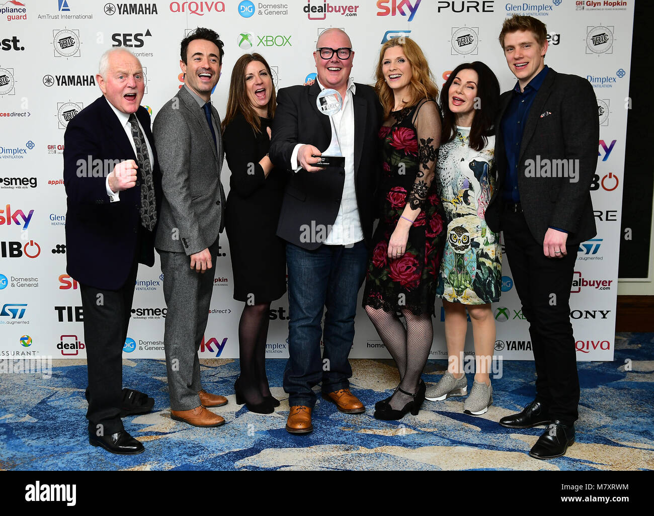 Ryan Hawley (right), Katherine Dow Blyton (third left), Dominic Brunt (centre), Chris Chittell (left), Samantha Giles (third right), Joseph McFadden (second left), Sally Dexter (second right) with the Soap of the Year Award for Emmerdale during the 2018 TRIC Awards at the Grosvenor House Hotel, London. Stock Photo