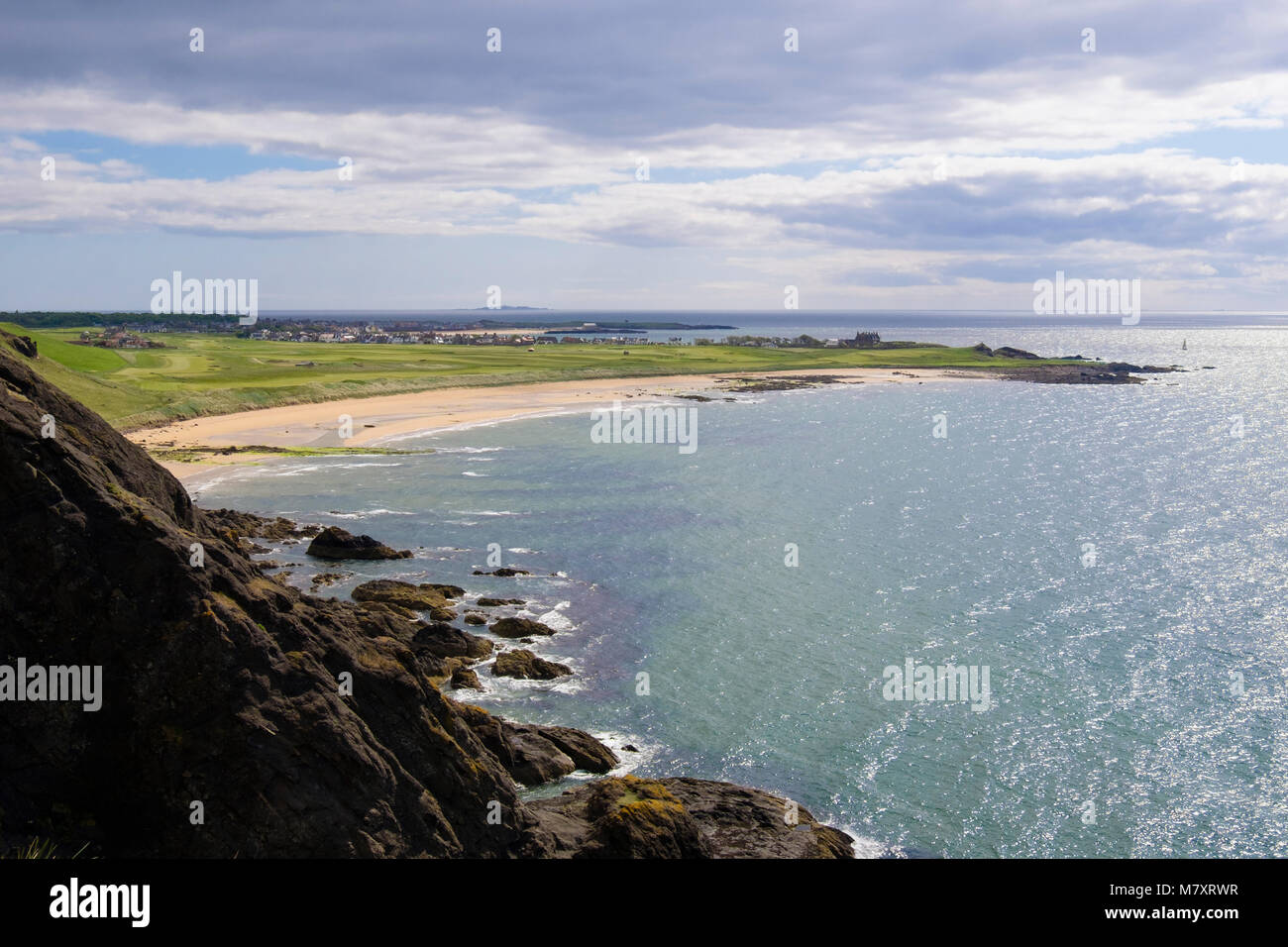 Rocky coastline at Kincraig Point with view to golf course by sandy beach at West Bay in Firth of Forth. Elie and Earlsferry, Fife, Scotland, UK Stock Photo