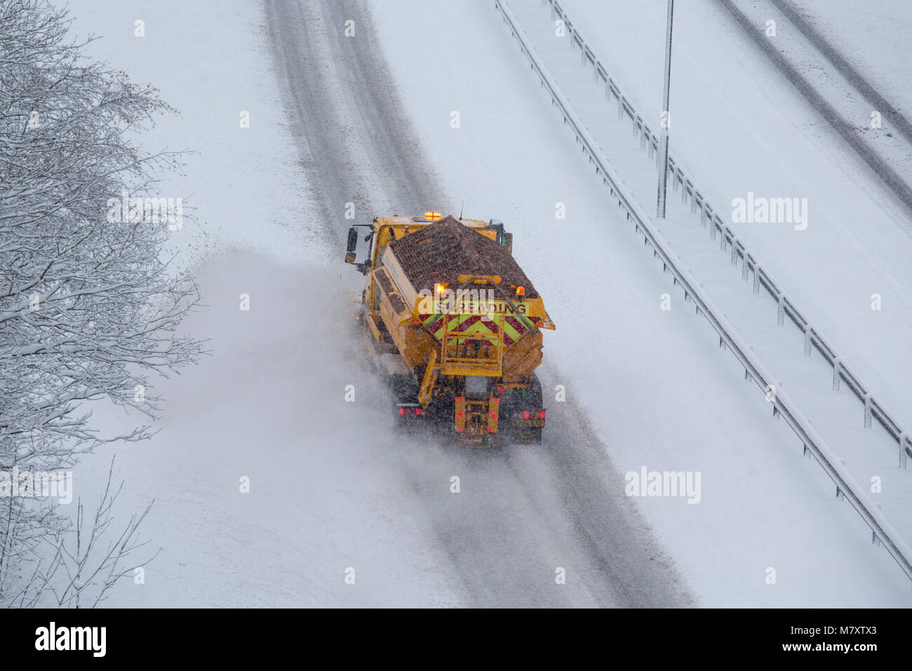 A gritting lorry on a dual carriageway in Redditch, Worcestershire, UK Stock Photo