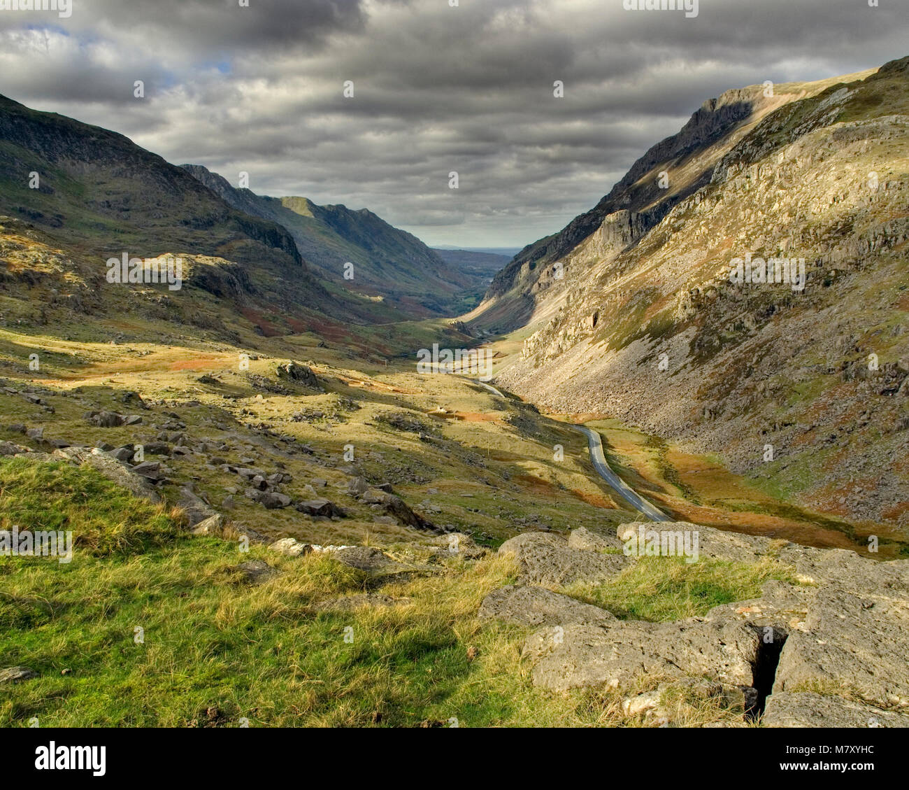 Sunlight and shadow on mountains lining the Llanberis Pass in Snowdonia, North Wales Stock Photo