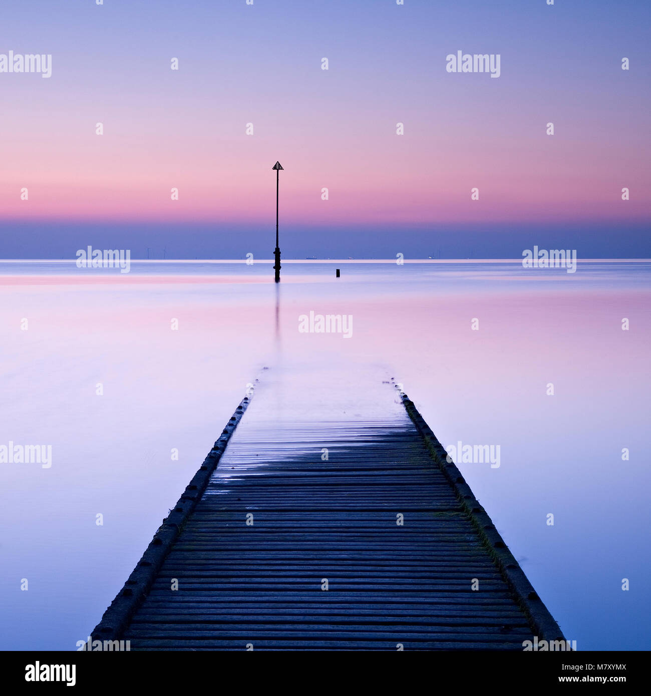 Wooden jetty and post in the sea at Llandudno, North Wales at dawn Stock Photo