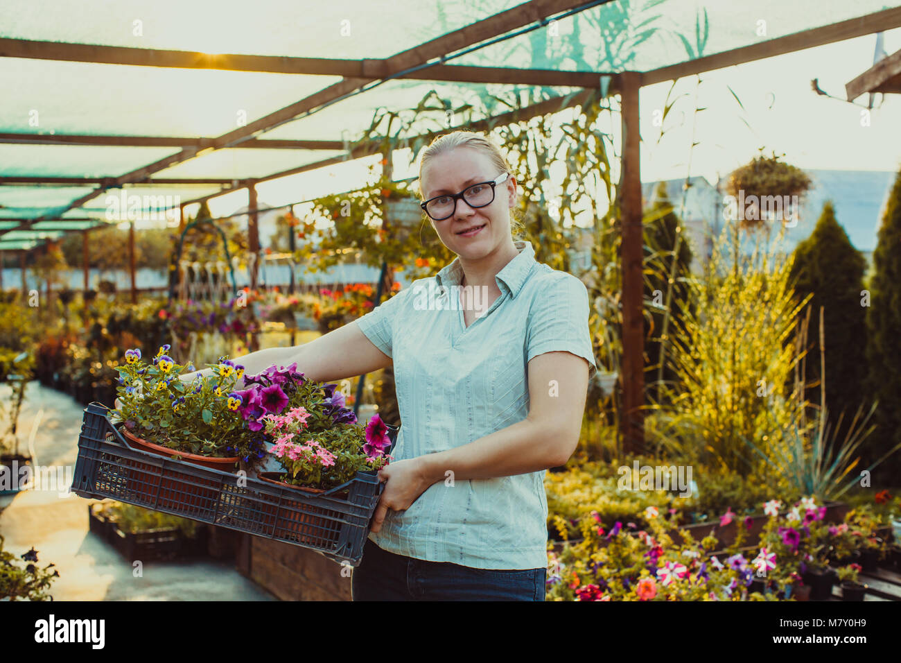 Happy gardener with plant Stock Photo - Alamy