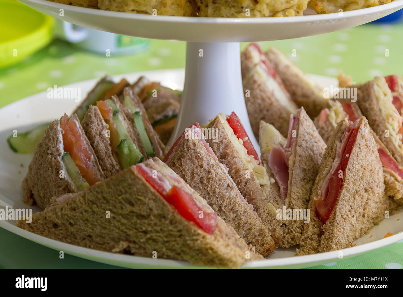 English afternoon tea consisting of a variety of sandwiches on a tiered cake stand Stock Photo