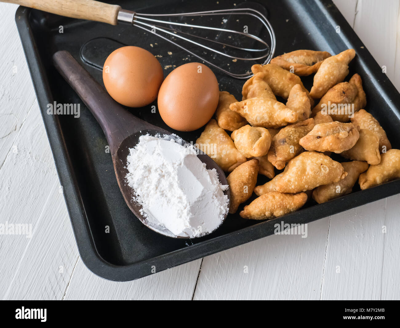 Karee puff, eggs and powder on white wooden background, Ingredients for cooking baking flour