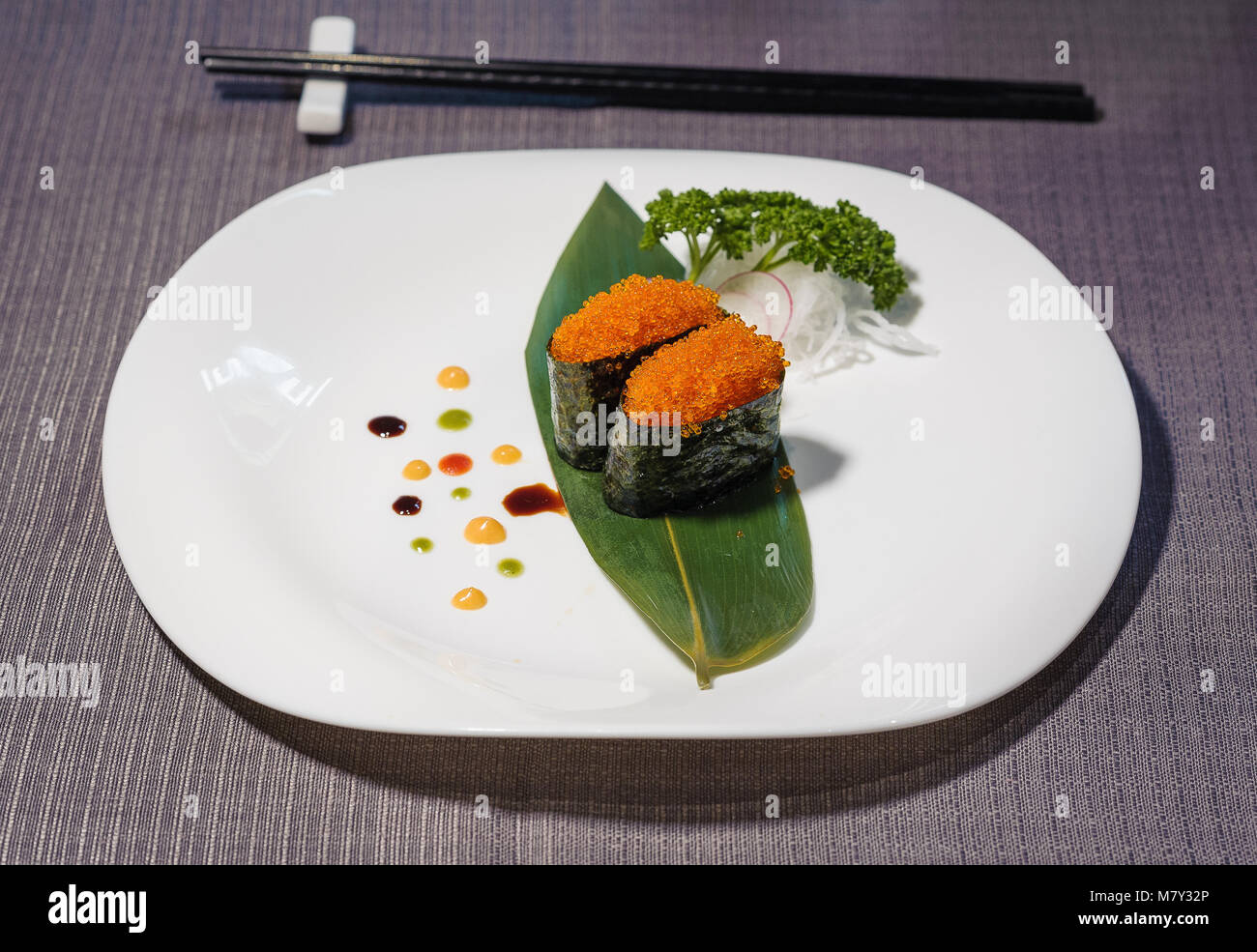 Fish Caviar Sushi Dish Served On Bamboo Leaf Decorative Sauces