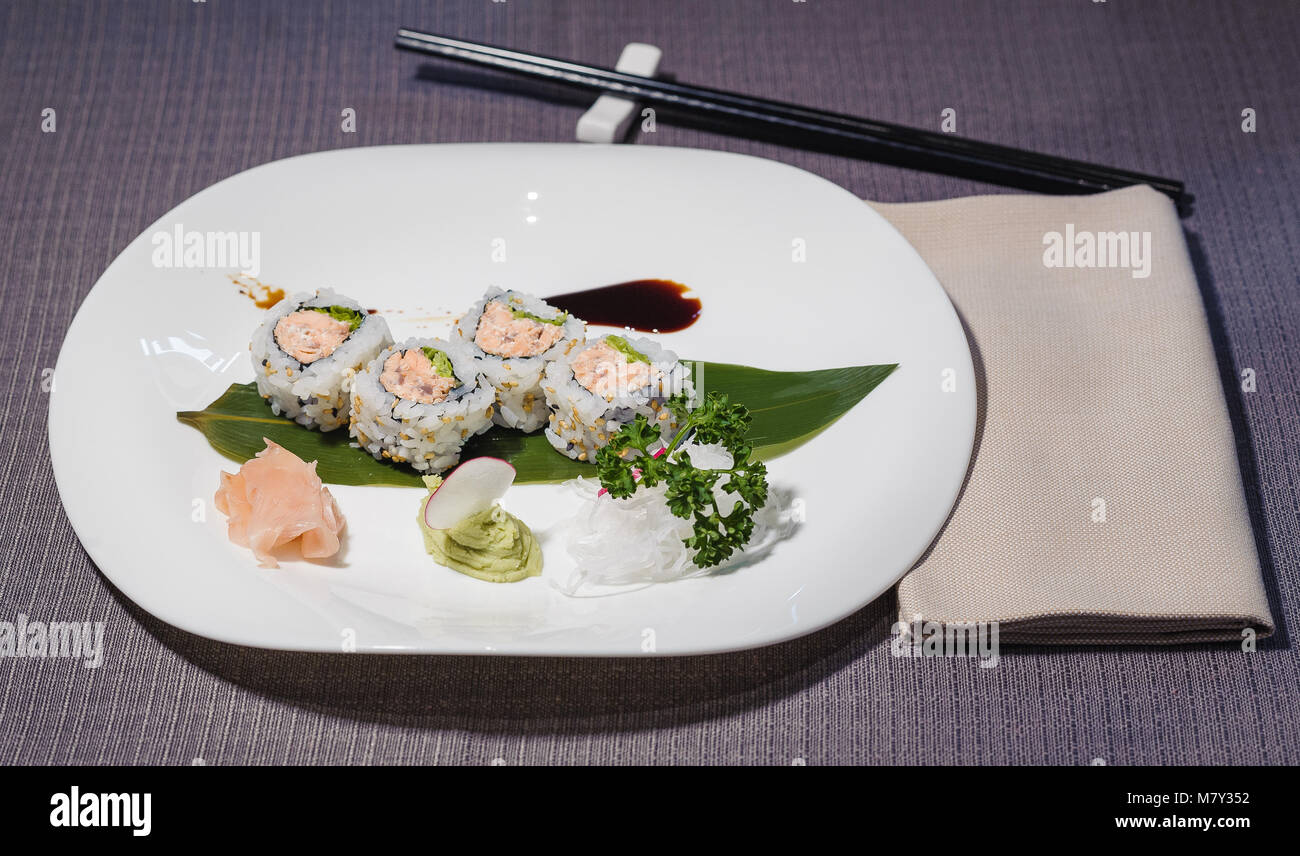 uramaki with salmon, creamy cheese, salad, breaded with black and white