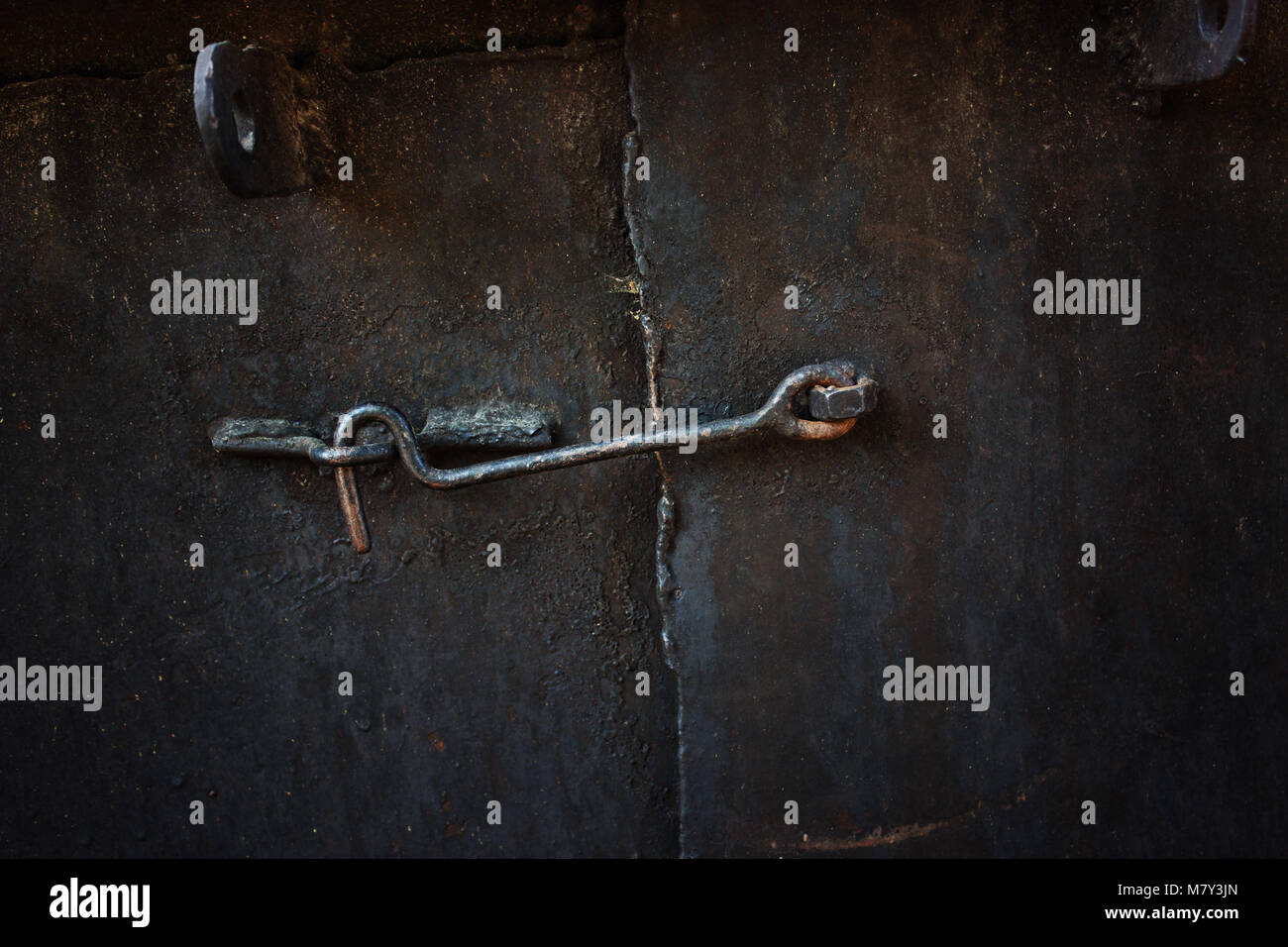 Old metal door closed on the hook Stock Photo - Alamy