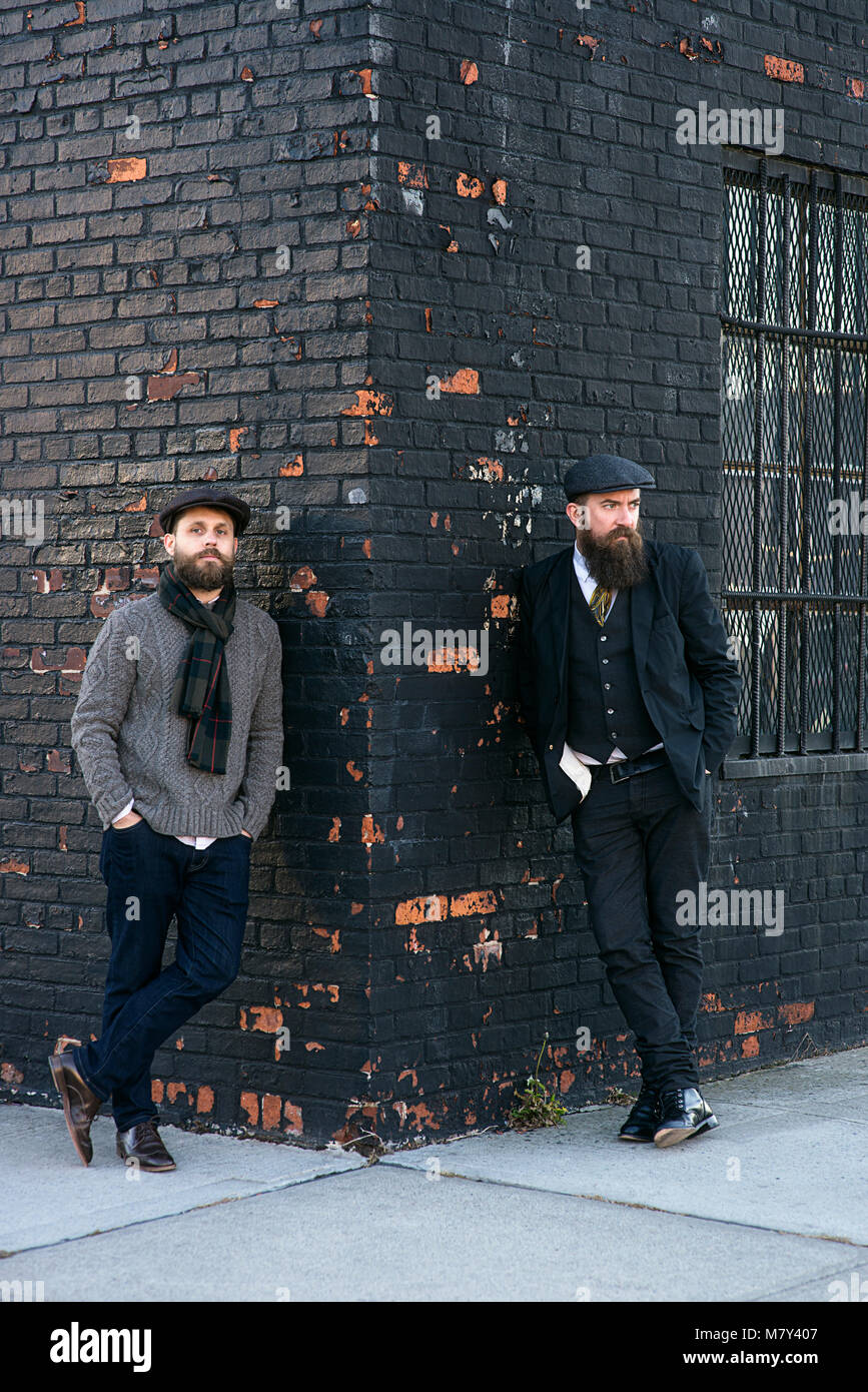 Two bearded men standing on a street corner. Stock Photo