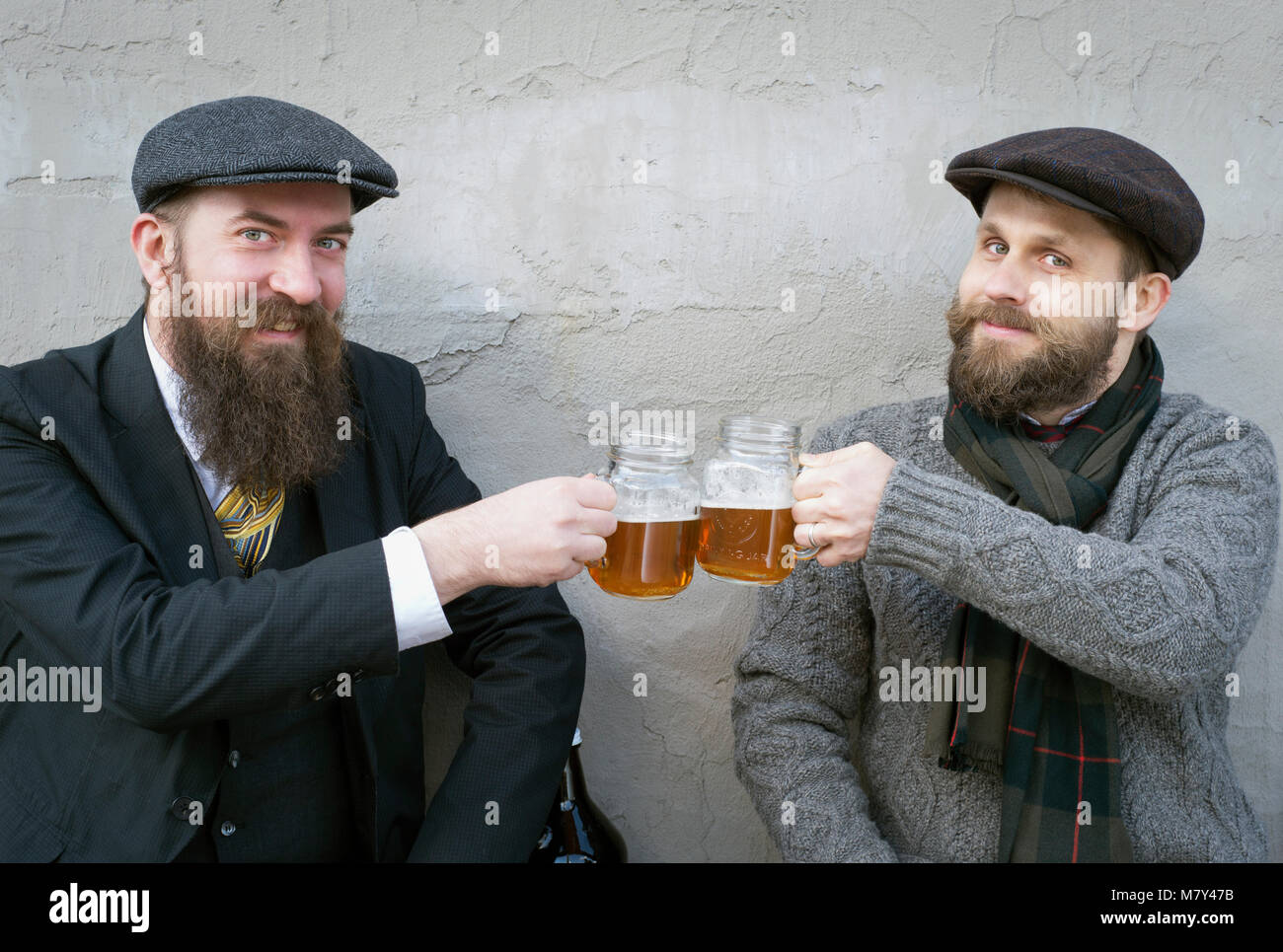 Two men with beards, drinking beer. Stock Photo