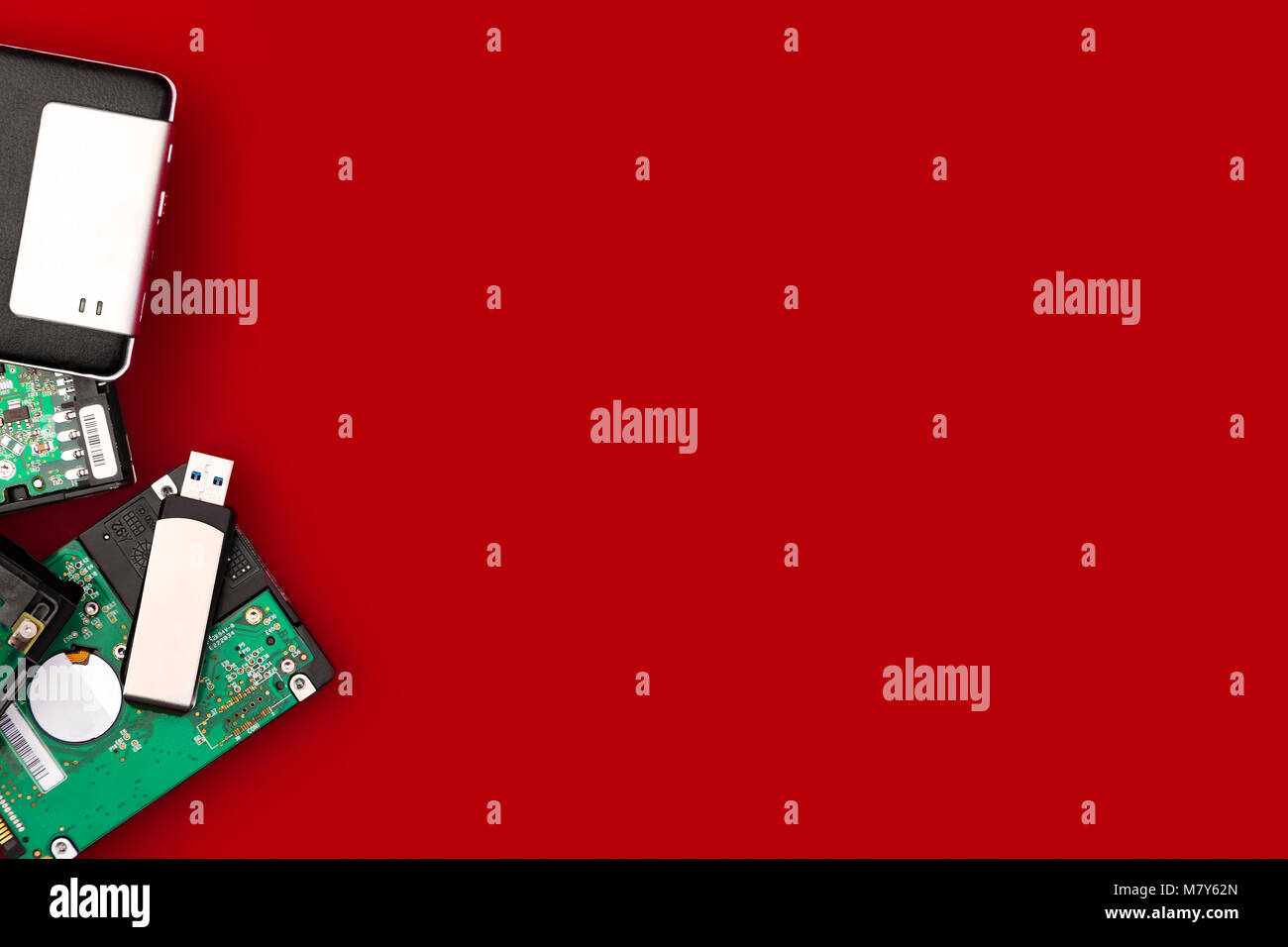 Hard drives and flash drive on the side of the frame on a red