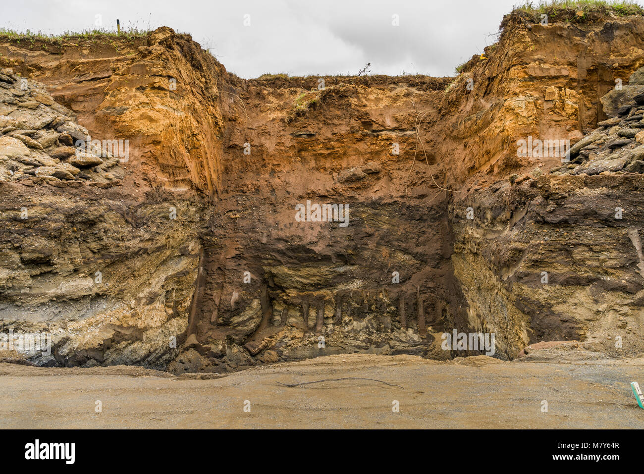 Multiple layers of earth showing deposits of ash from eruptions and volcanic activity, South Coast, Iceland Stock Photo