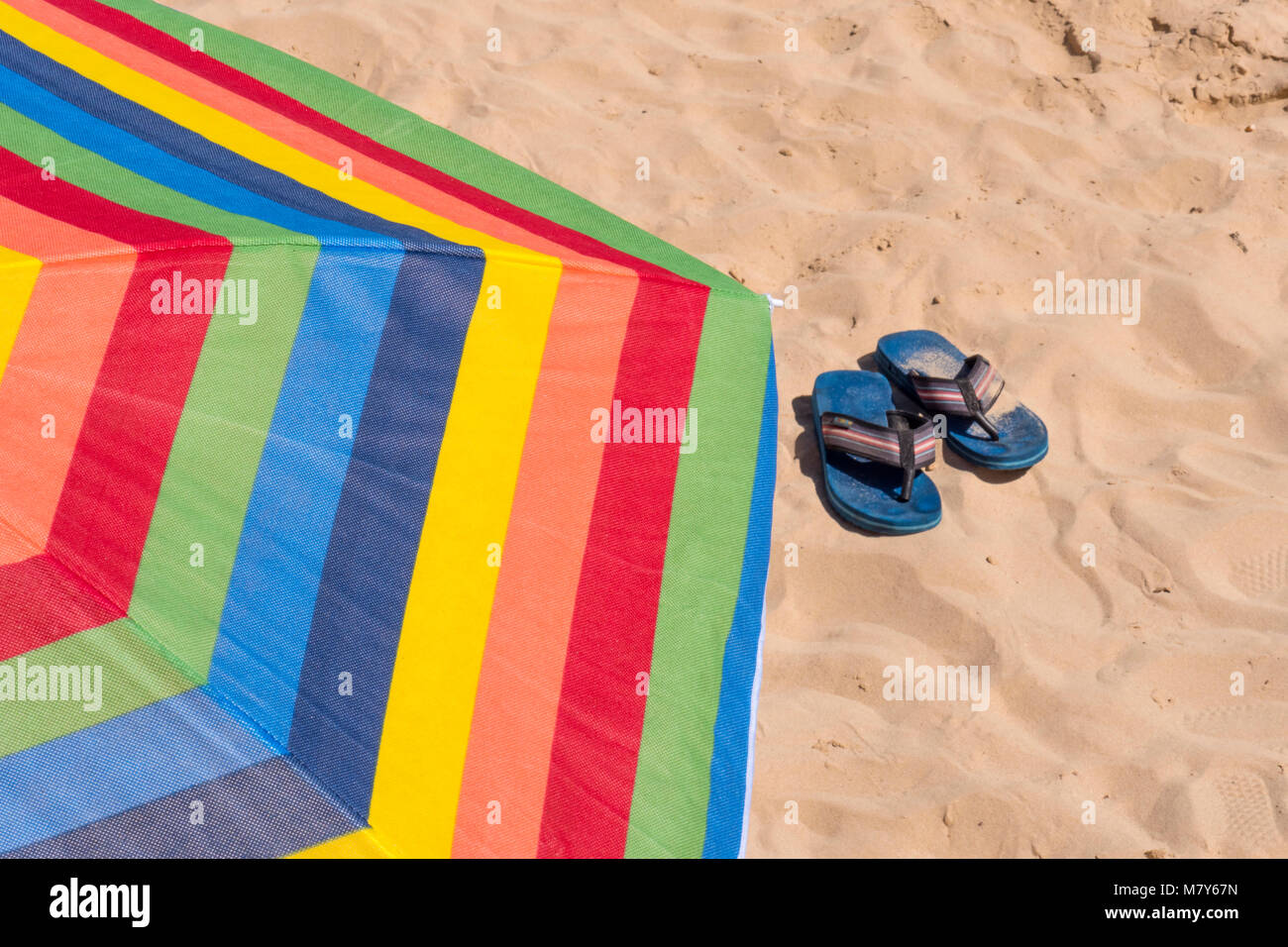 Parasol on the beach Flip Flops Sand Stock Photo - Alamy