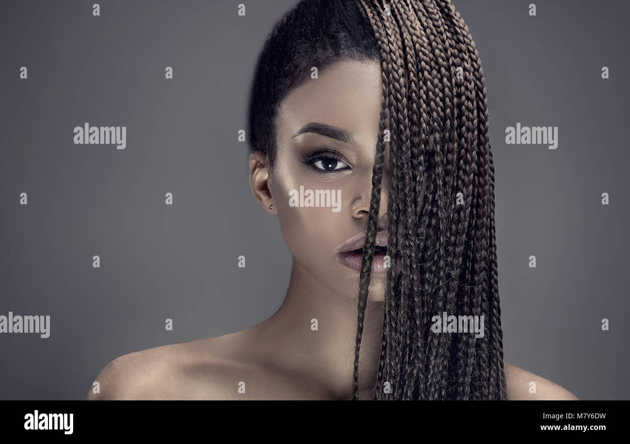 Portrait of beautiful young african girl with braids, studio shot Stock ...