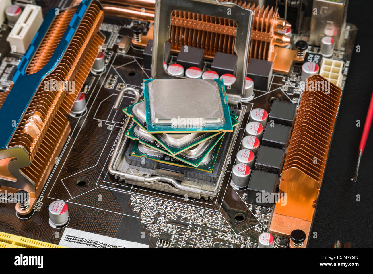 Four processors in an old and dusty game motherboard on a black desk. Past  Computer and New Technologies Stock Photo - Alamy