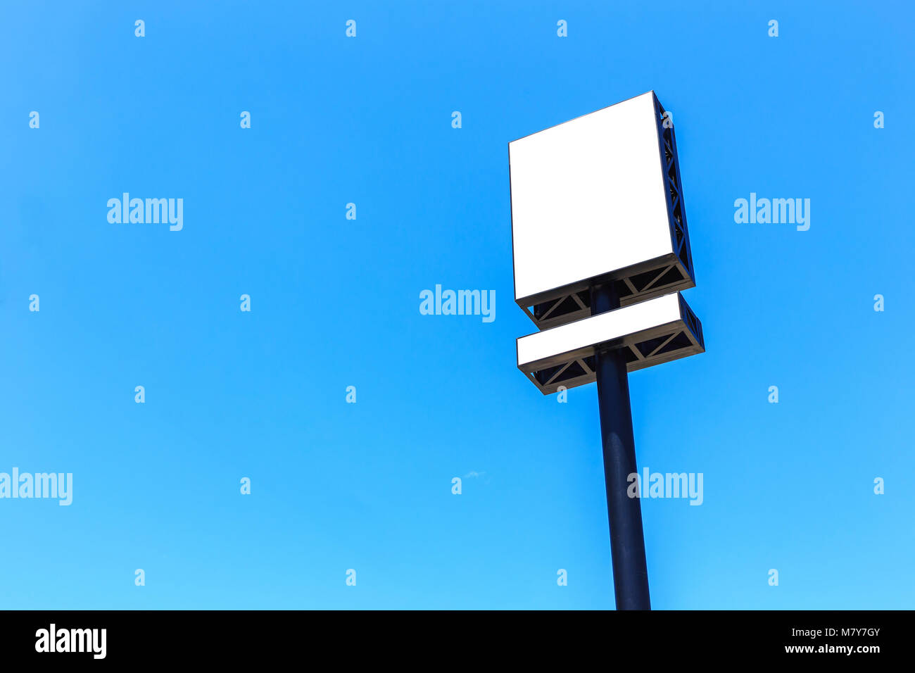 Empty large white blank advertising billboard on blue sky background. For design and advertisement concept Stock Photo
