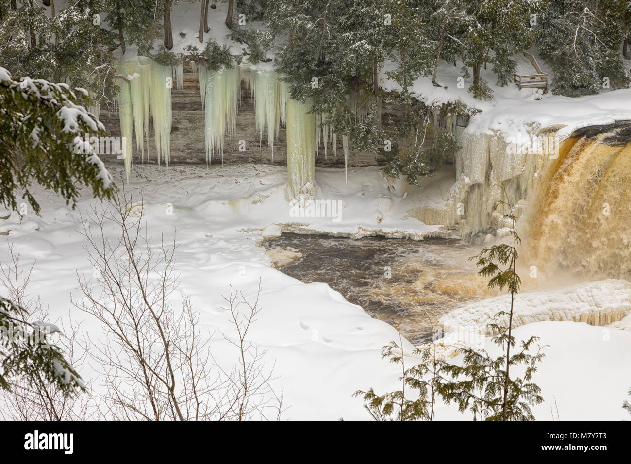 A winter wonderland surrounds Tahquamenon Falls, a popular waterfall in the Upper Peninsula of Michigan. Stock Photo