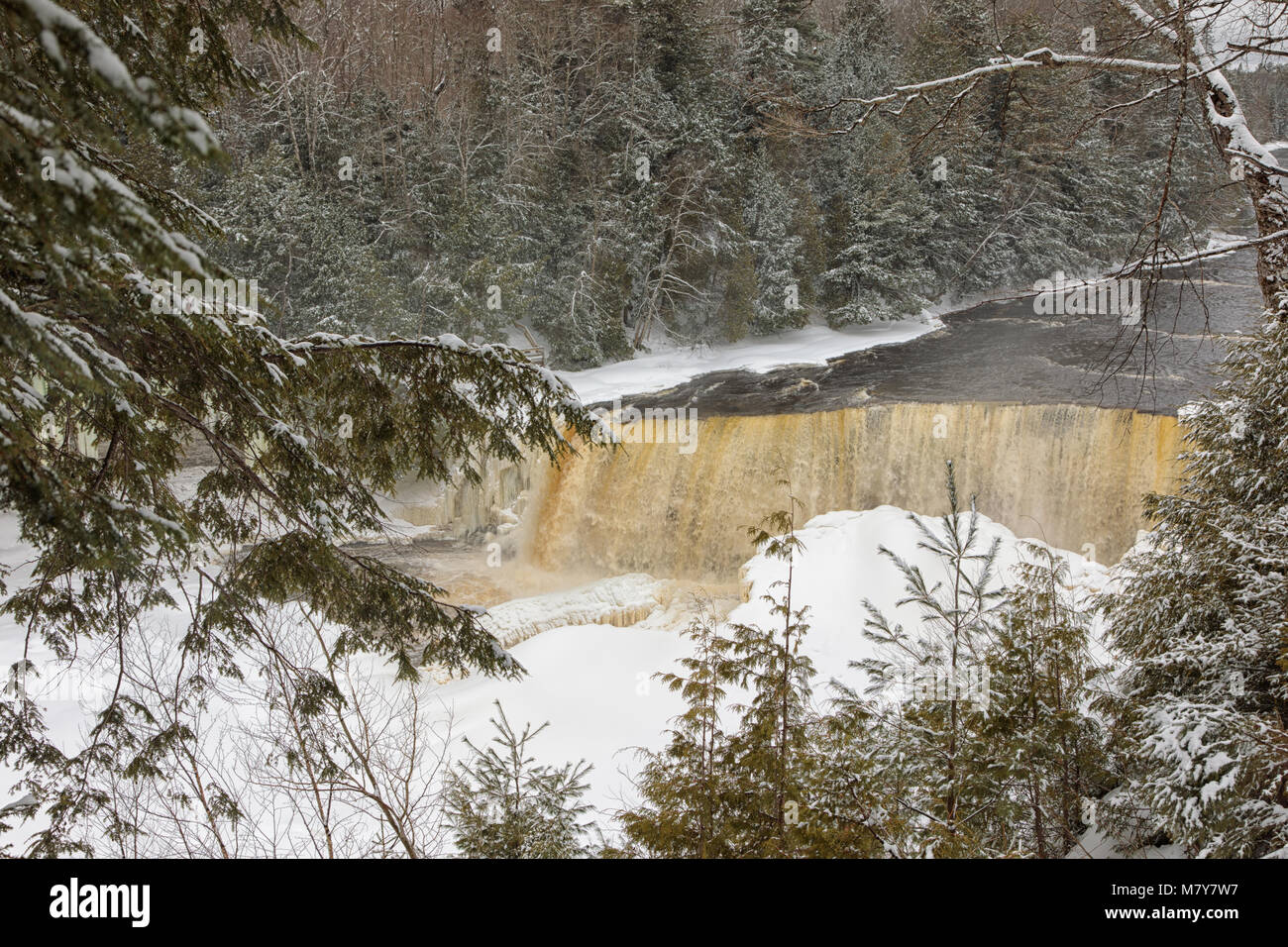 A winter wonderland surrounds Tahquamenon Falls, a popular waterfall in the Upper Peninsula of Michigan Stock Photo