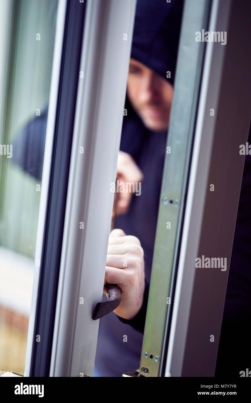 Person breaking into property Stock Photo