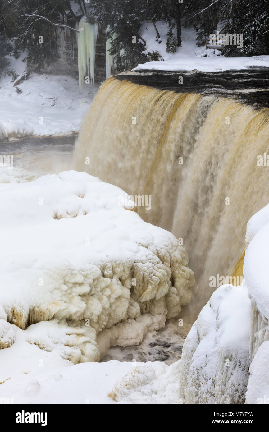A winter wonderland surrounds Tahquamenon Falls, a popular waterfall in the Upper Peninsula of Michigan. Stock Photo