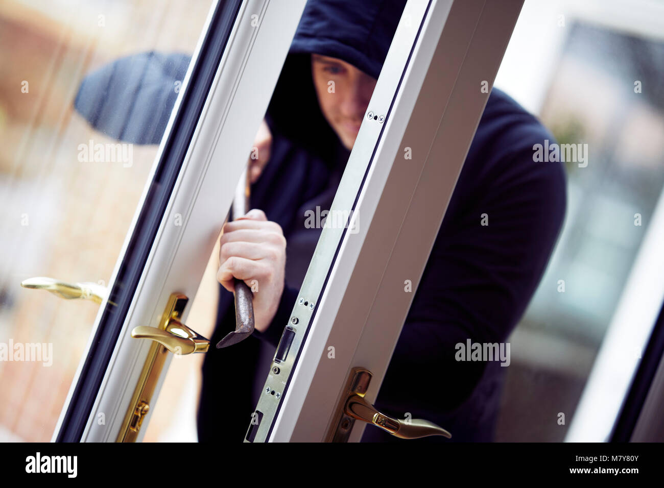 Person breaking into property Stock Photo