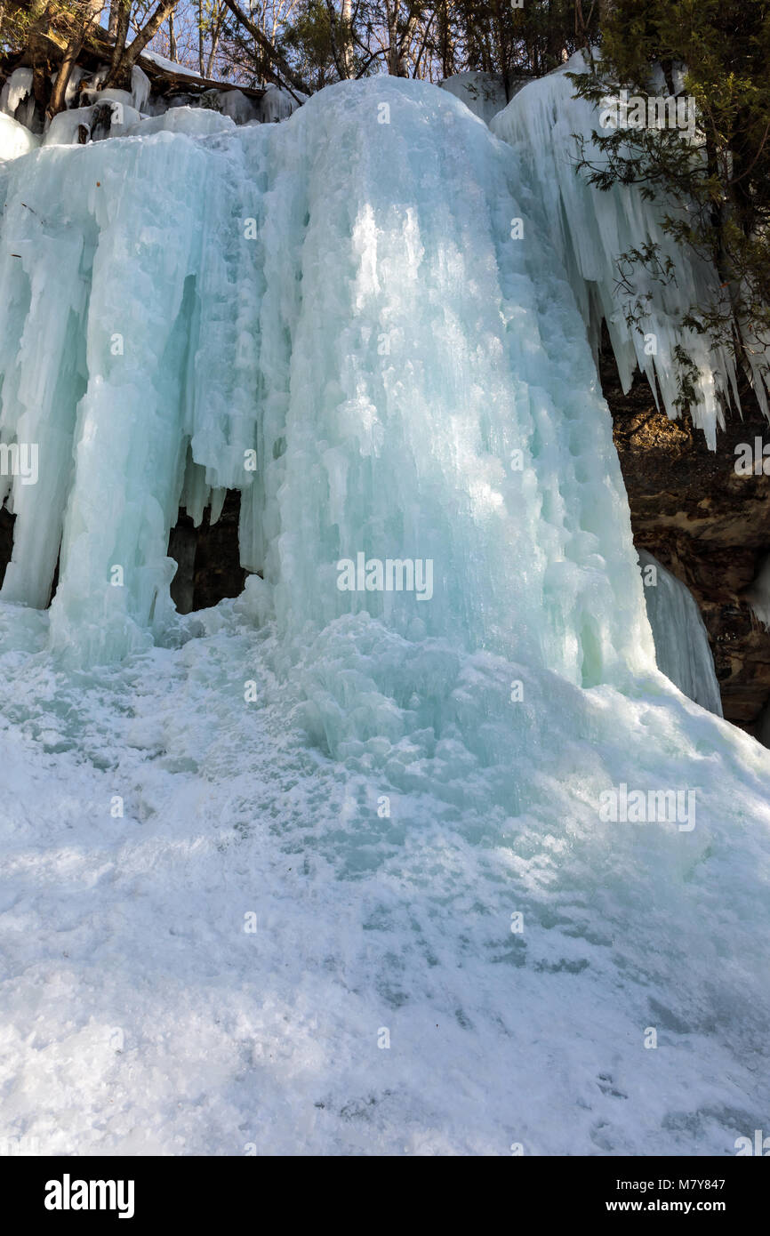 Ice caves and ice curtains form along the Pictured Rocks escarpment on Sand Point Road in Munising Michigan. These ice curtains are popular for ice cl Stock Photo