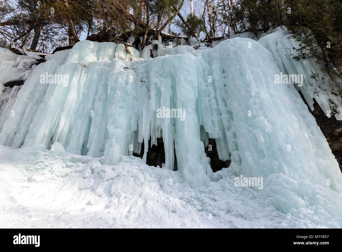 Ice caves and ice curtains form along the Pictured Rocks escarpment on Sand Point Road in Munising Michigan. These ice curtains are popular for ice cl Stock Photo