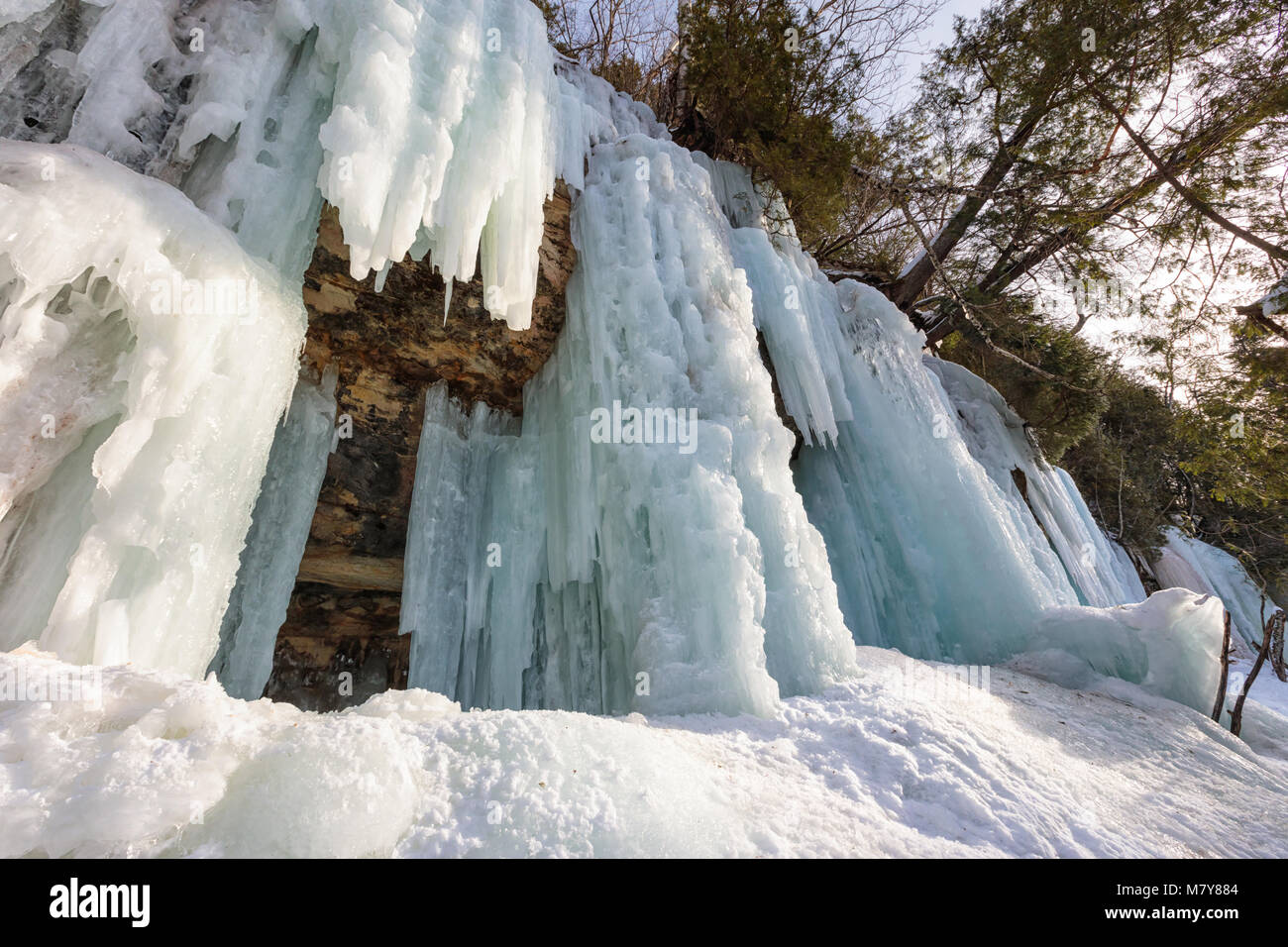 Ice caves and ice curtains form along the Pictured Rocks escarpment on Sand Point Road in Munising Michigan. These ice curtains are popular for ice cl Stock Photo