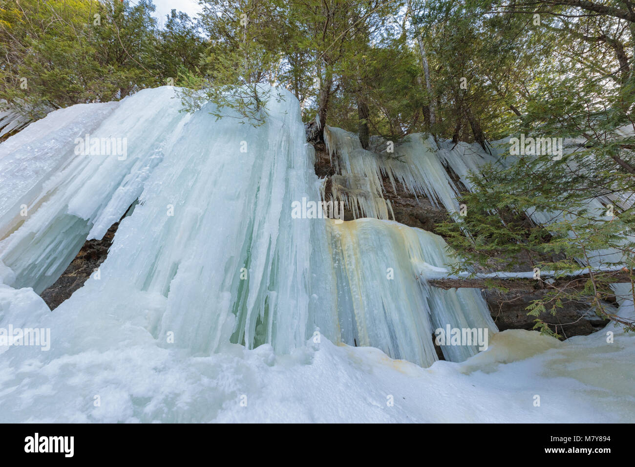 Ice caves and ice curtains form along the Pictured Rocks escarpment on Sand Point Road in Munising Michigan. These ice curtains are popular for ice cl Stock Photo