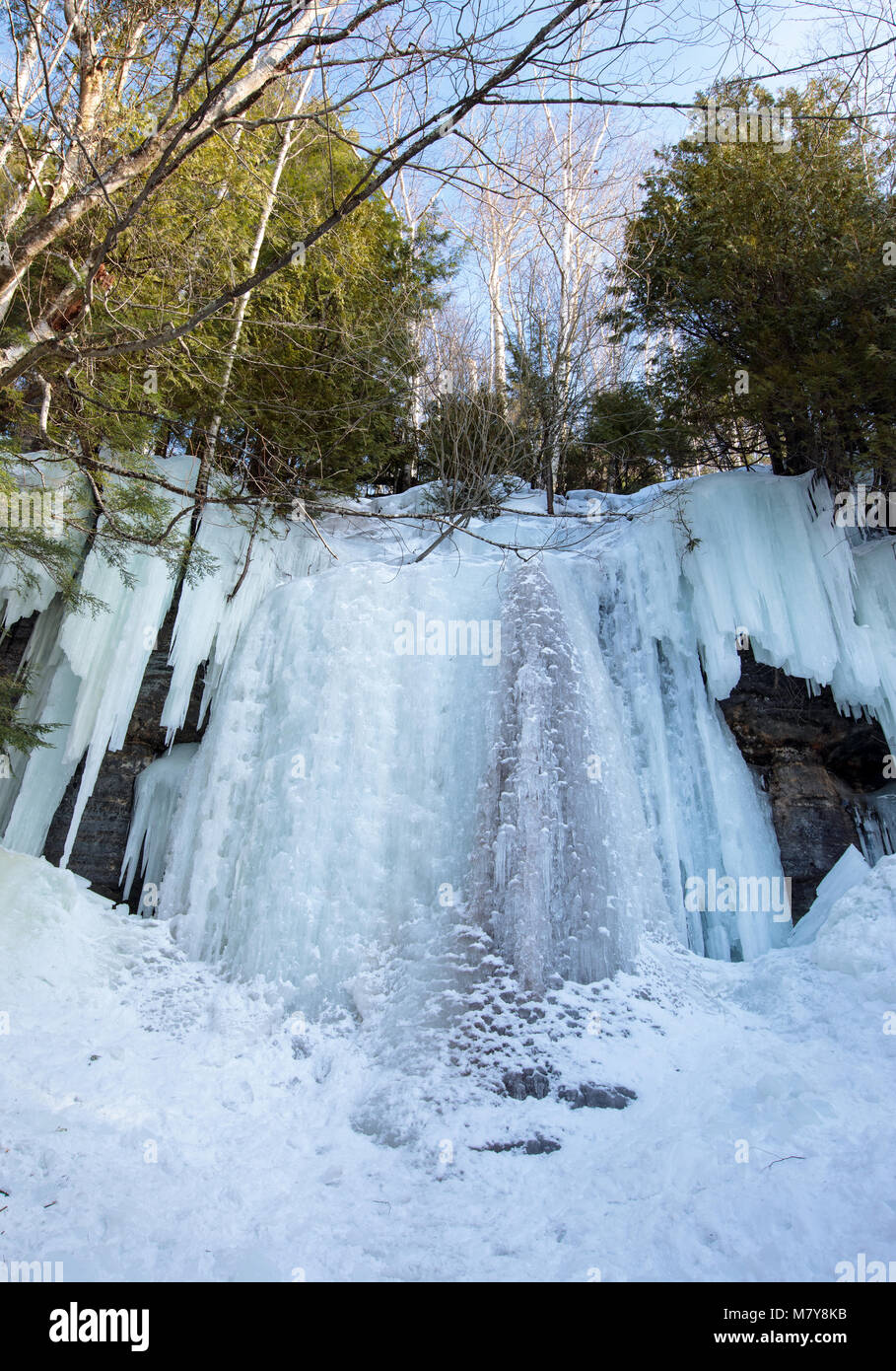 Ice caves and ice curtains form along the Pictured Rocks escarpment on Sand Point Road in Munising Michigan. These ice curtains are popular for ice cl Stock Photo