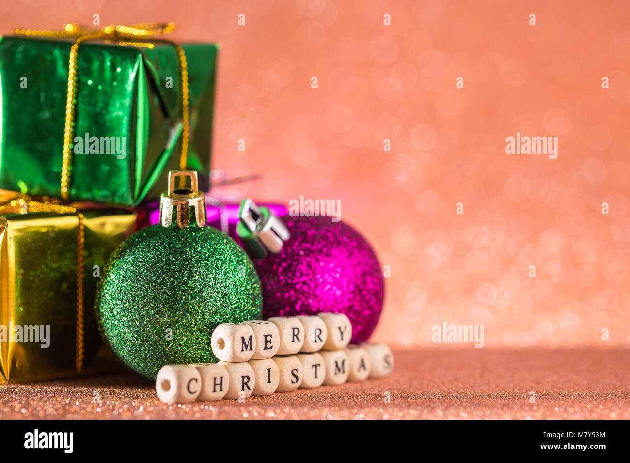 Christmas and New Year Background. Christmas Ball and Gift Box on Red Holiday and New Year Abstract Blurred Defocused Background. For design or photo Stock Photo