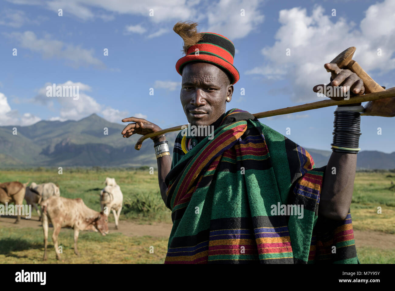 In the rural areas of North Eastern Uganda, the Karamajong tribe live a simple pastoralist life. When a saw this man with his herd of cows I thought h Stock Photo