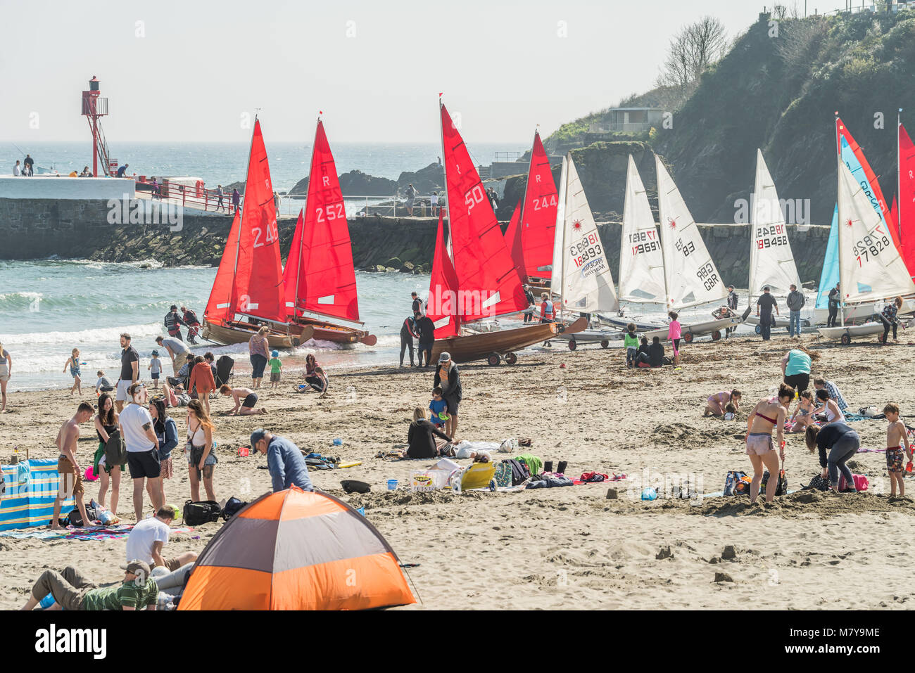 Launching sailing dinghies from Looe beach Stock Photo Alamy