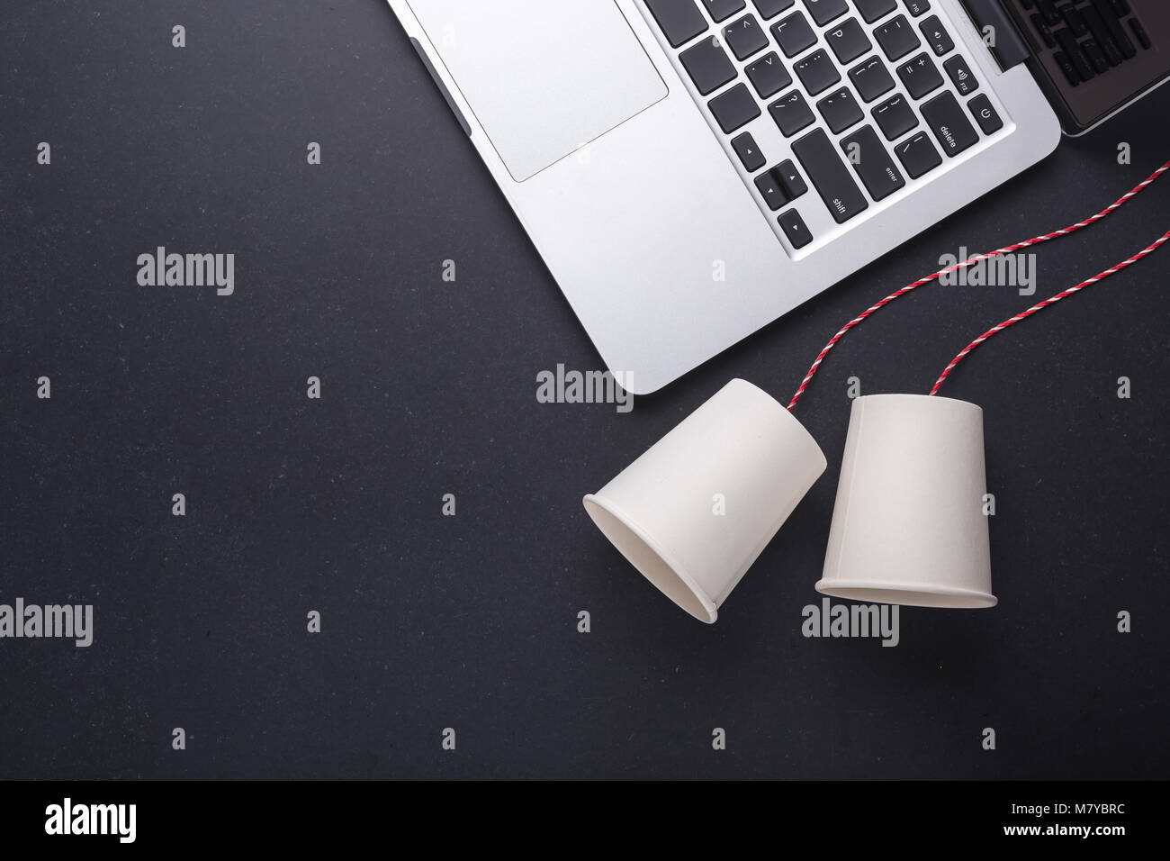 Two white paper cup connect with red rope used for classic phone and ...