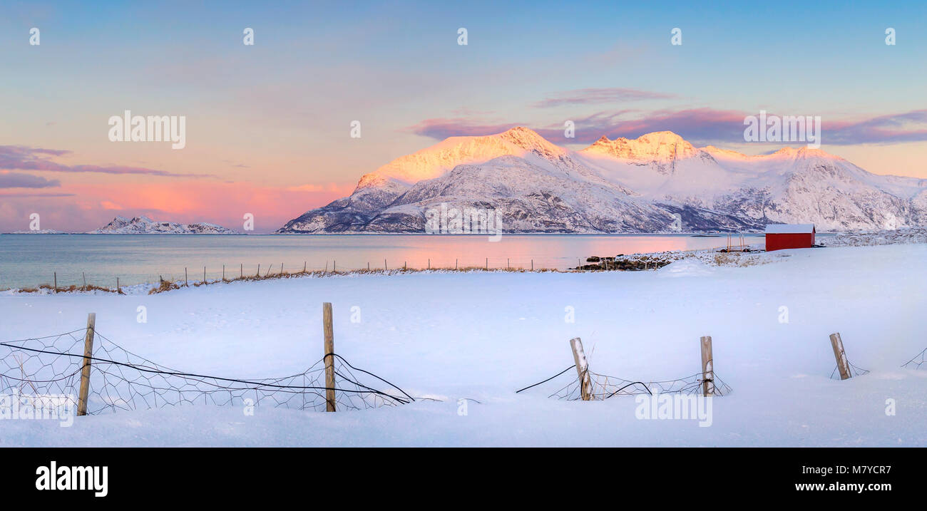 Winter landscape image in Northern Norway with snow and a red cottage. Stock Photo