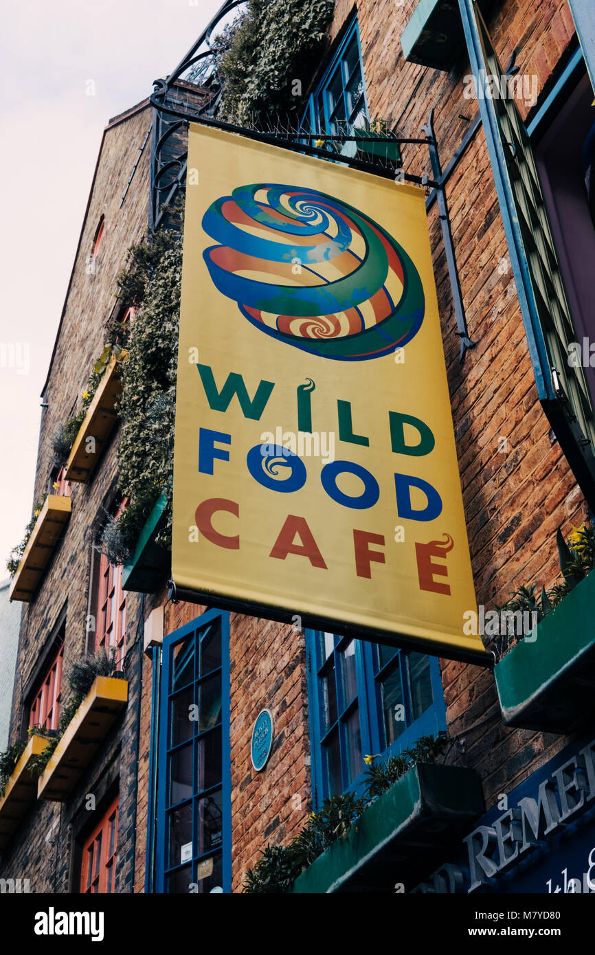 Wild Food Cafe sign in Neal's Yard, Covent Garden, London, UK. In total Neal's Yard contains seven health-food cafes. Stock Photo