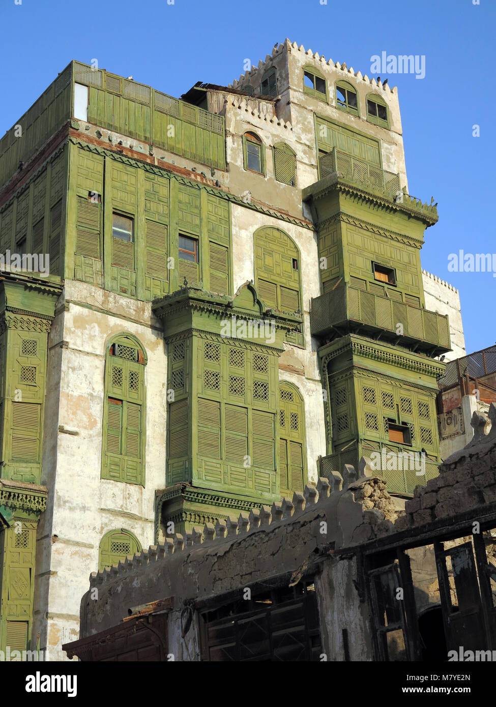 street life, architecture and impressing old houses with wooden bay windows and mashrabya in Al Balad, Jeddah, Saudi Arabia Stock Photo