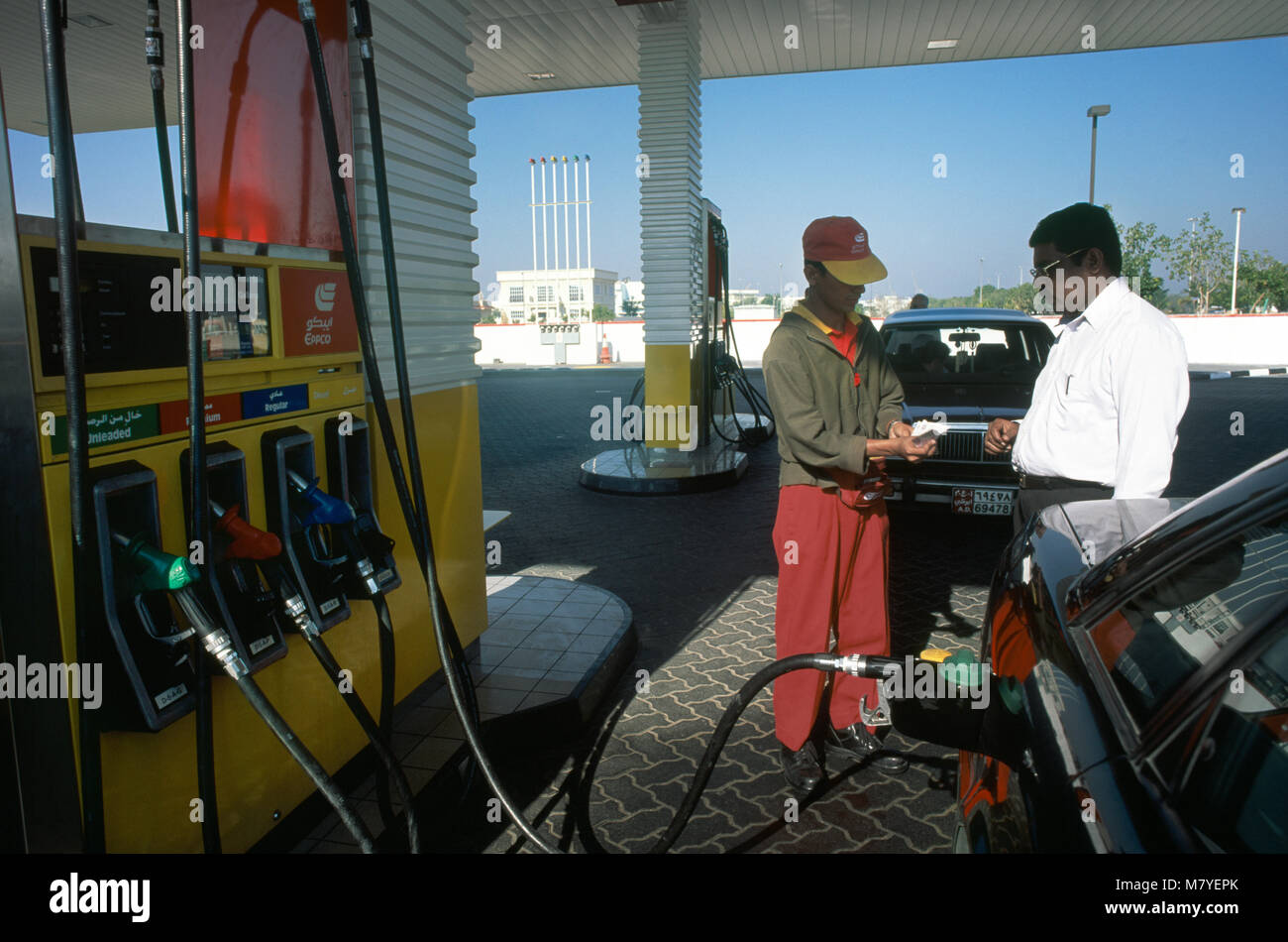 Dubai UAE Man Paying Petrol Pump Attendant At Petrol Station Stock