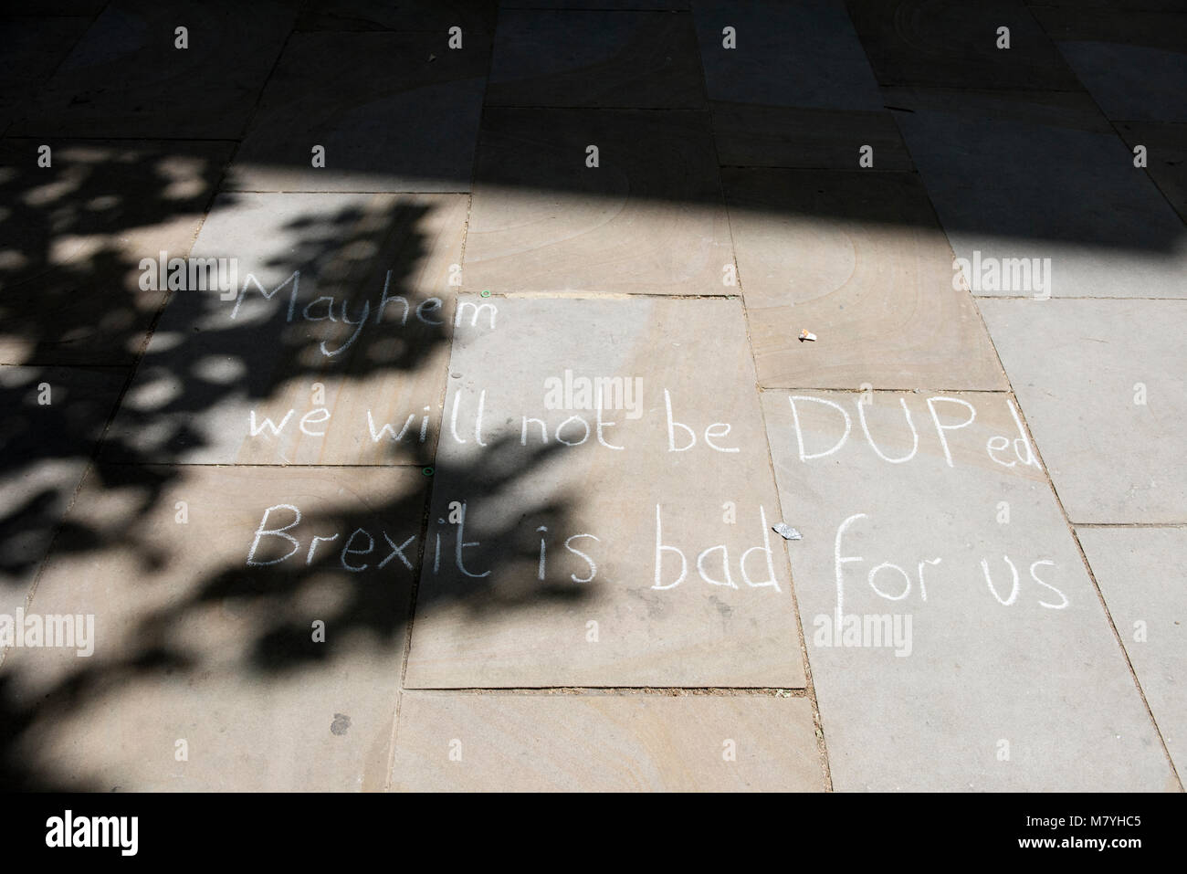 A message reading: 'Mayhem we will not be DUPed Brexit is bad for us' is written on the pavement by the anti-Brexit protesters in London, UK. Stock Photo