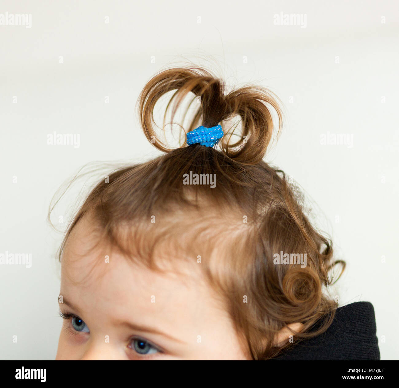 Hair hairstyle shaped fountain or onion of a toddler baby girl. Stock Photo