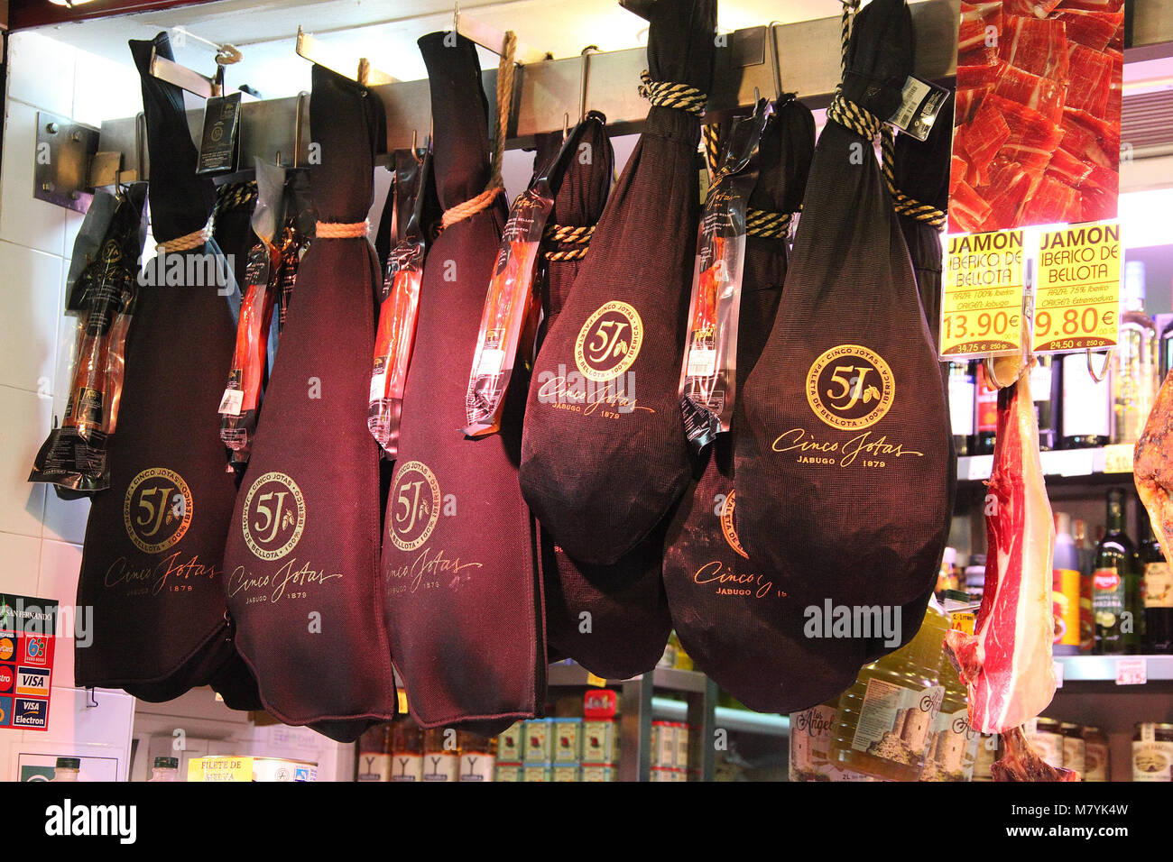 Famous Cinco Jotas Iberian hams hanging up in Seville Stock Photo