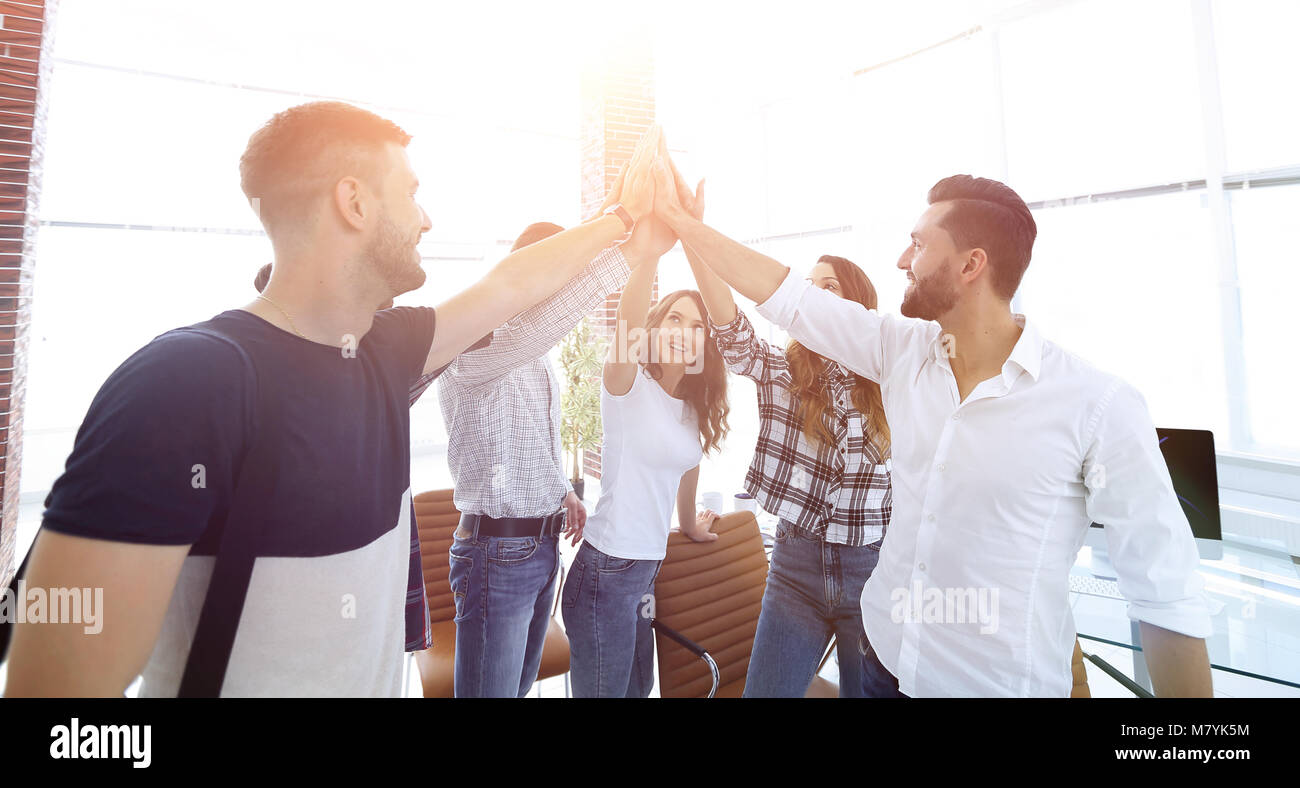 creative team giving each other a high five Stock Photo - Alamy