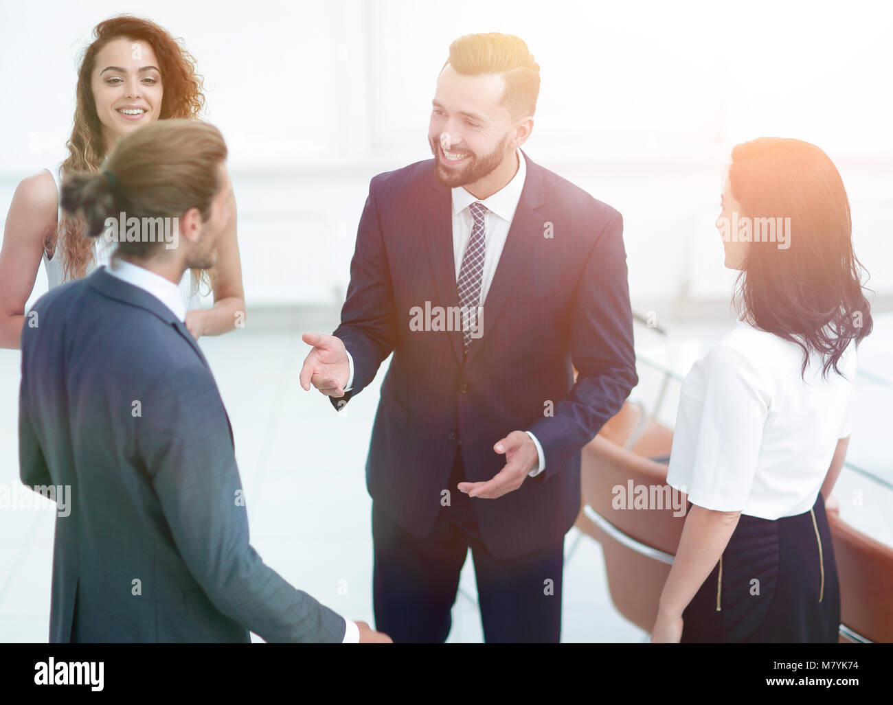 business team talking, standing in office Stock Photo - Alamy
