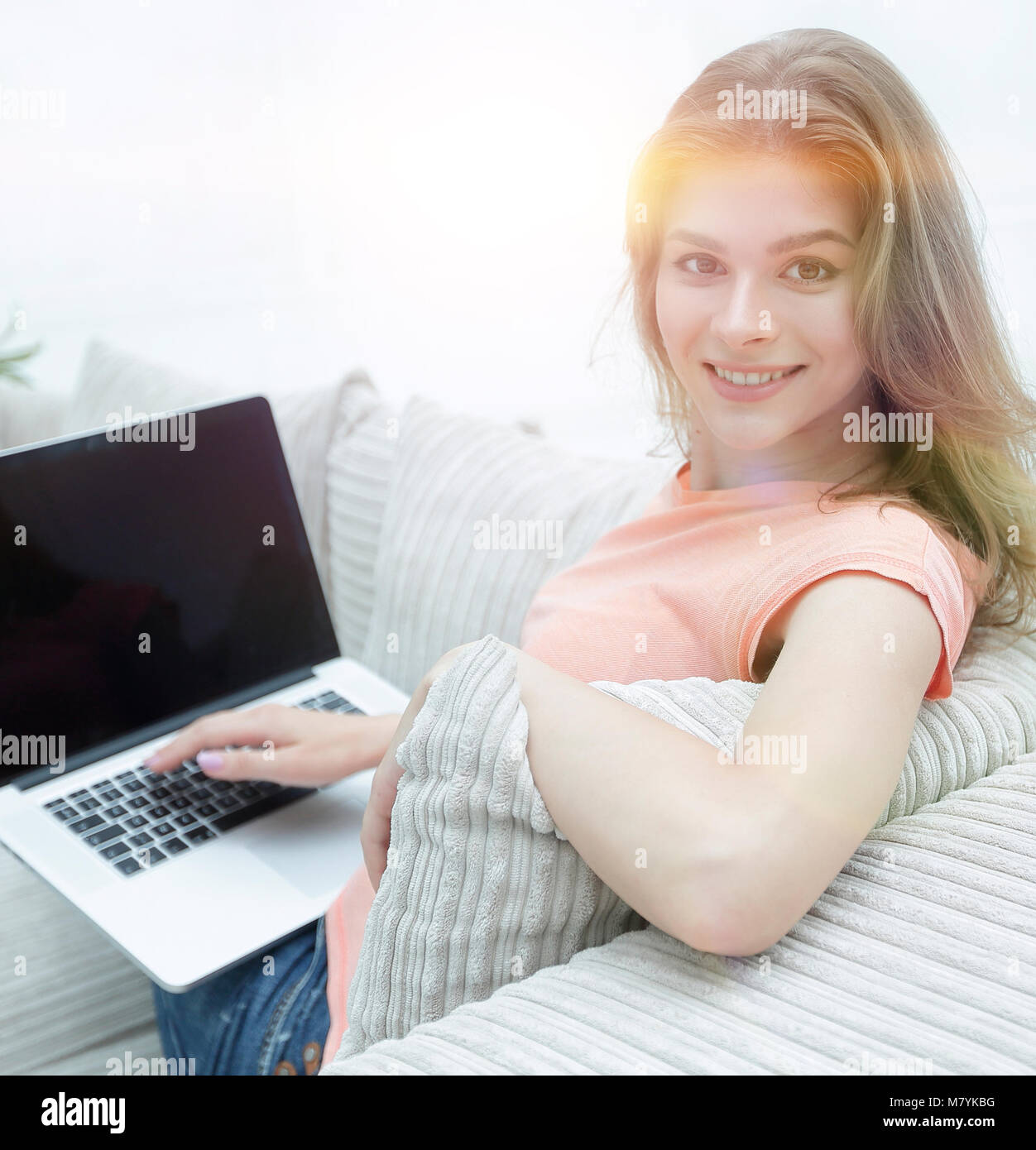 young woman working with laptop sitting on sofa Stock Photo - Alamy